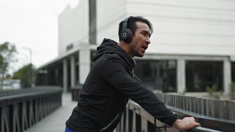 man in sportswear running on a bridge