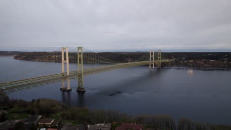 the tacoma narrows bridge spanning the calm waters of puget sound, wide aerial orbit