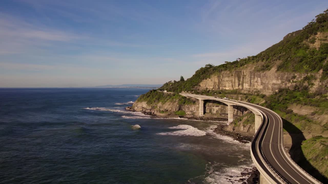 Scenic view of an elevated road bridge along the cliffside coast, offering breathtaking views of the ocean, captured near Vinh Hy Bay, Binh Thuan Province, Vietnam