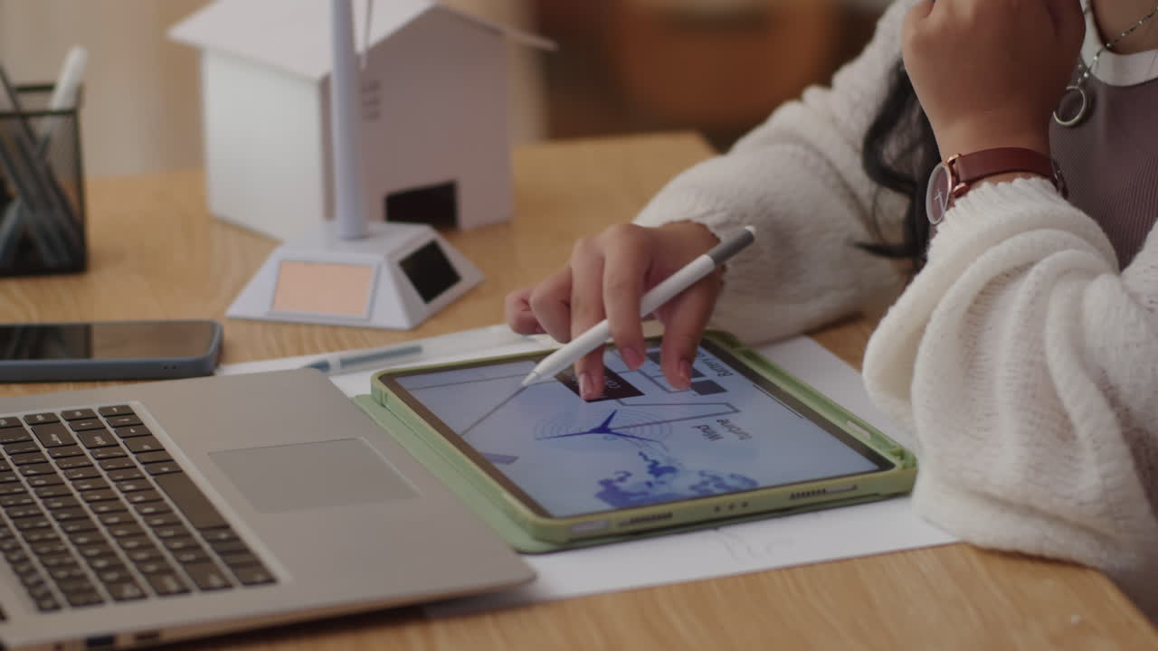 Schoolgirl Using Application on Tablet when Doing Homework