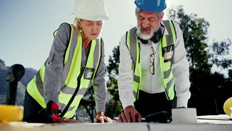 construction workers reviewing blueprints on site