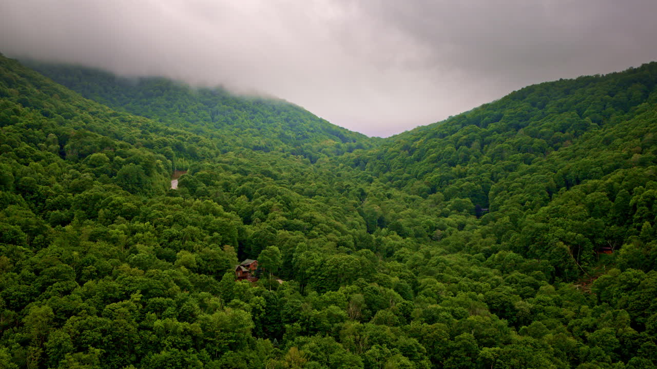 Smoky Mountains cloaked in rolling fog, drone-eye view