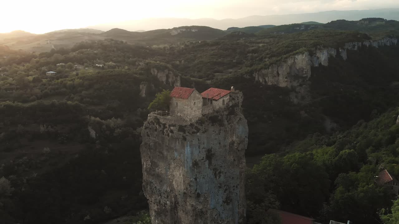 Sunset Aerial fly Katskhi Pillar Monastery Rising Above the Georgian Landscape