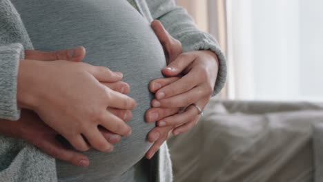 close up hands on pregnant belly proud couple embracing parentood husband gently holding wife enjoying security excited for motherhood