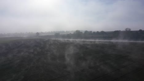 Flying-Through-Scattered-Wispy-Clouds-Over-Plains-In-Countryside