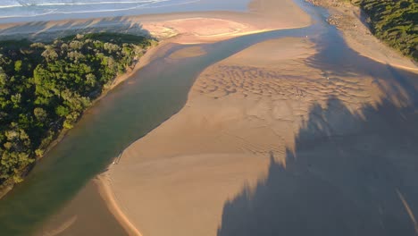 Golden-Sand-In-Moonee-Creek-With-Ocean-Waves-Crashing-On-Green-Bluff-Headland-In-Australia