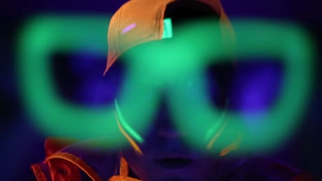 man is dancing in neon clothes close up