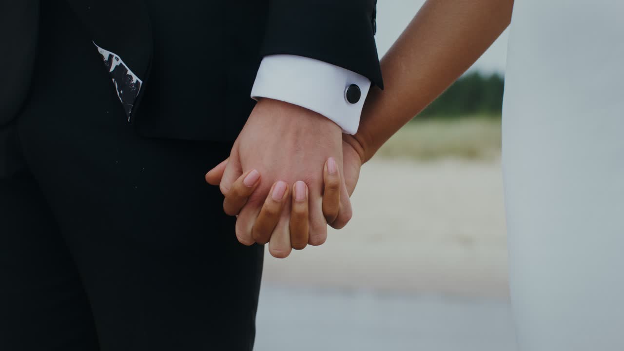 Bride and Groom Holding Hands at Wedding