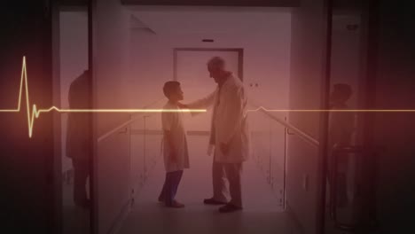 Animation-of-heart-rate-monitor-over-caucasian-senior-male-doctor-talking-to-a-boy-at-hospital