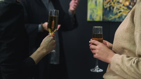 people toasting with champagne in an art gallery