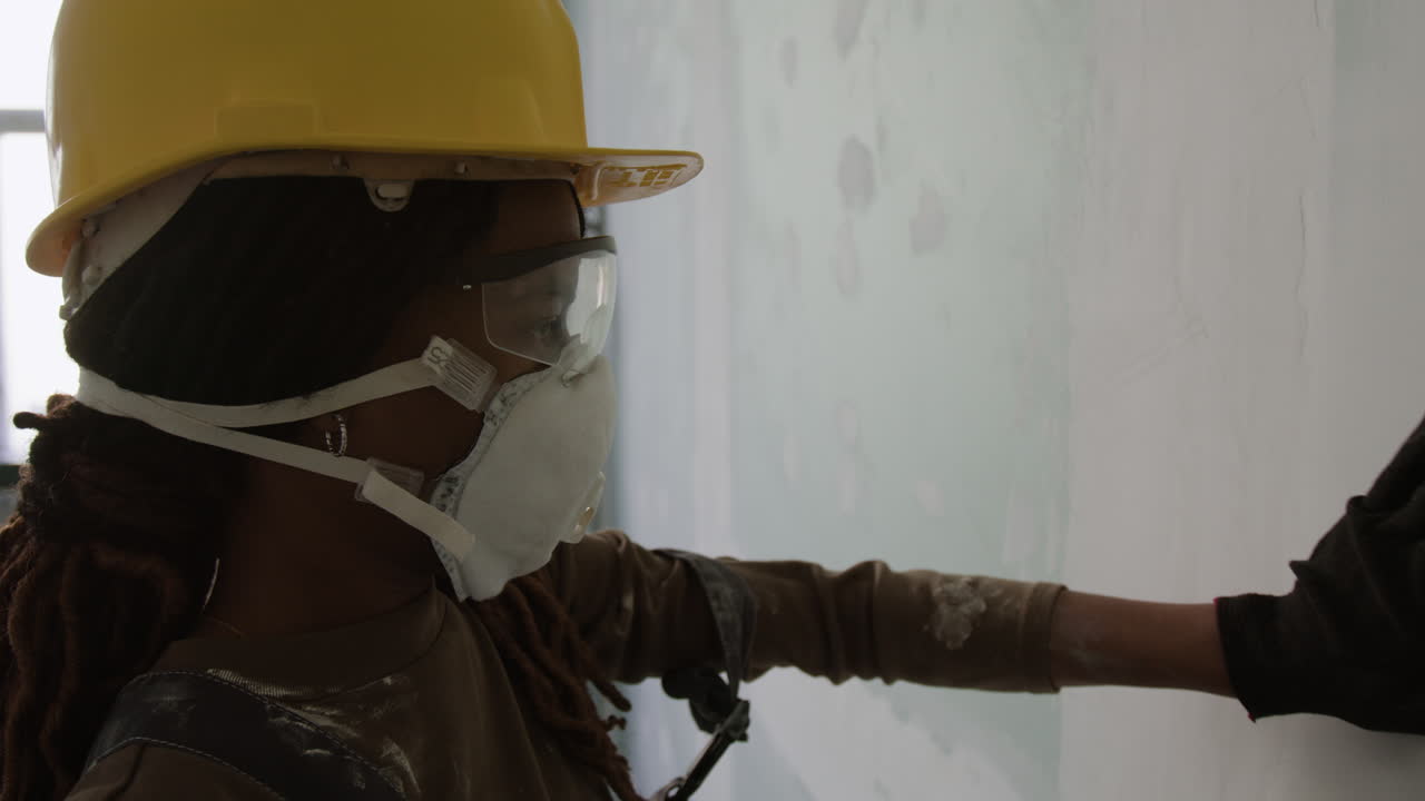 Construction Worker Repairing a Wall