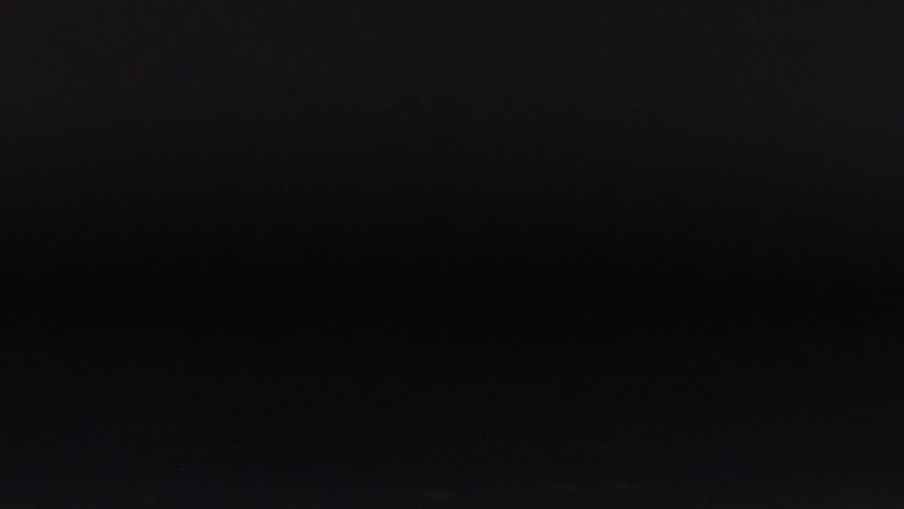 A vibrant tennis ball moves across a dark surface in a series of frames.