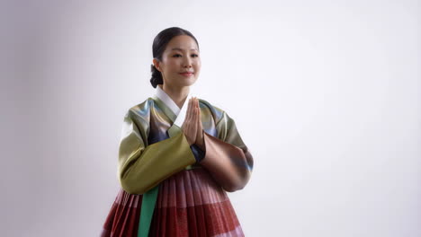 korean woman in hanbok performing a respectful traditional bow