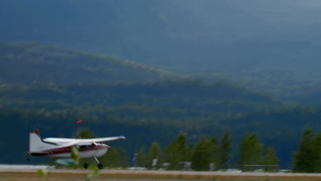 airplane taking off from runway, animation of forested mountains in background