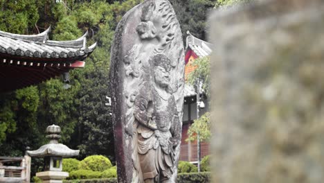 slide shot of an old stone statue in kyoto, japan 4k slow motion, close up