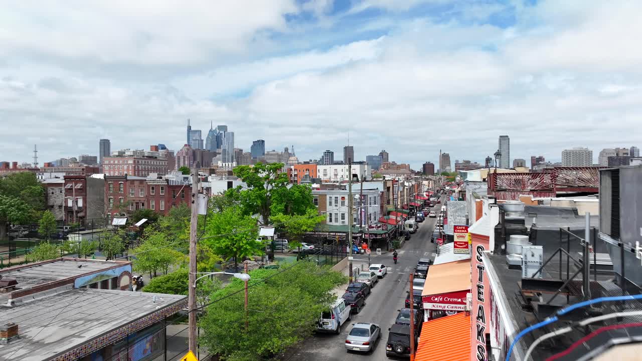 Geno's Steaks and Urban Street Scene in Philadelphia with City Skyline