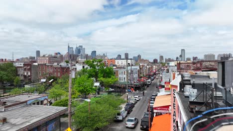 geno's steaks and urban street scene in philadelphia with city skyline