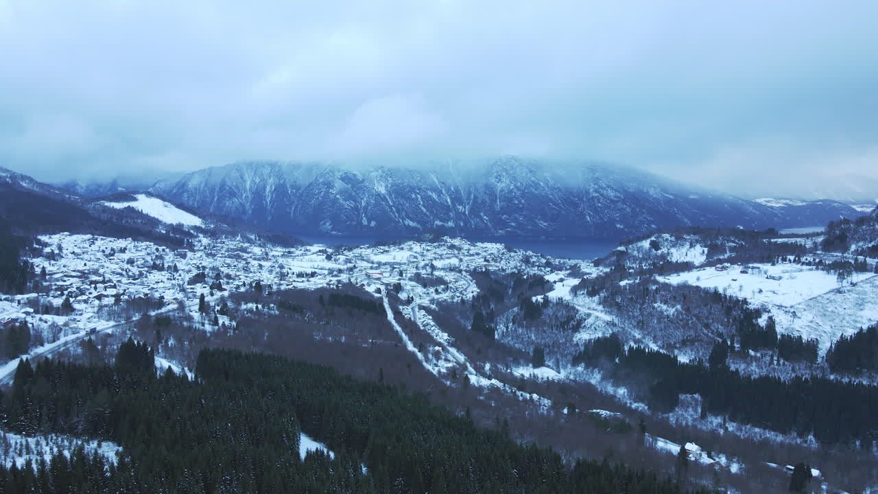 Aerial view over a small place called Stranda in Norway covered with snow