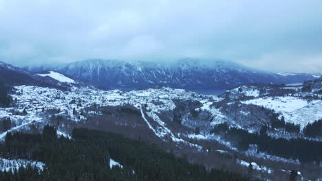 aerial view over a small place called stranda in norway covered with snow