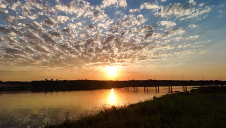 landscape of a bridge over the paraná river while the sun goes down in a beautiful sunset