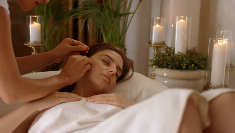 woman receiving a relaxing spa facial treatment