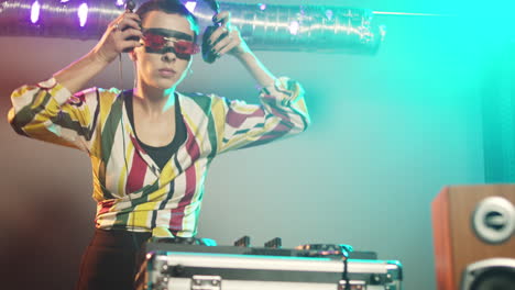 woman performer mixing sounds at stereo turntables