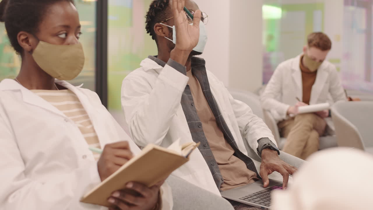 Afro American Male Medical Student Taking Notes on Laptop at Lecture