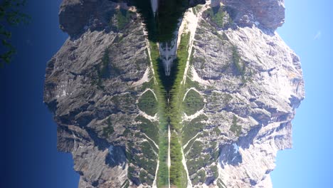 symmetric reflection of croda del becco mountain in lago di braies