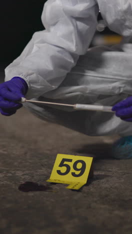 a crime scene investigator collects evidence at a crime scene.