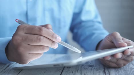 person using a tablet with a stylus