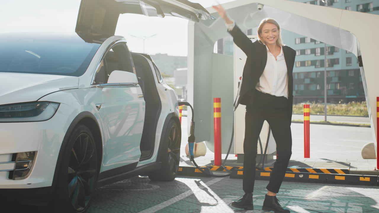 충전 스테이션에서 ev를 충전하는 여성과 흥분