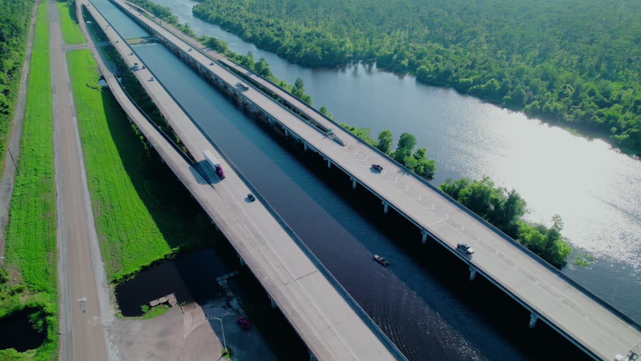 Long elevated highway bridge crossing the Ponchatoula River in Louisiana, with a semi-truck driving along it on a sunny day