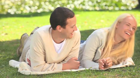 young couple talking on the grass