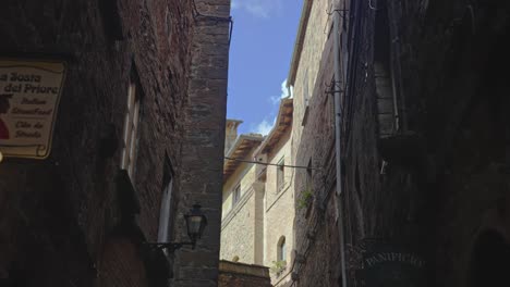 walking the quiet back streets of the walled town of volterra, province of perugia, italy