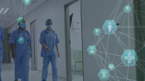 animation of networks of connections with icons over diverse doctors wearing face masks