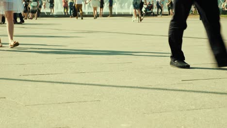 crowd of people walking on sunny streets