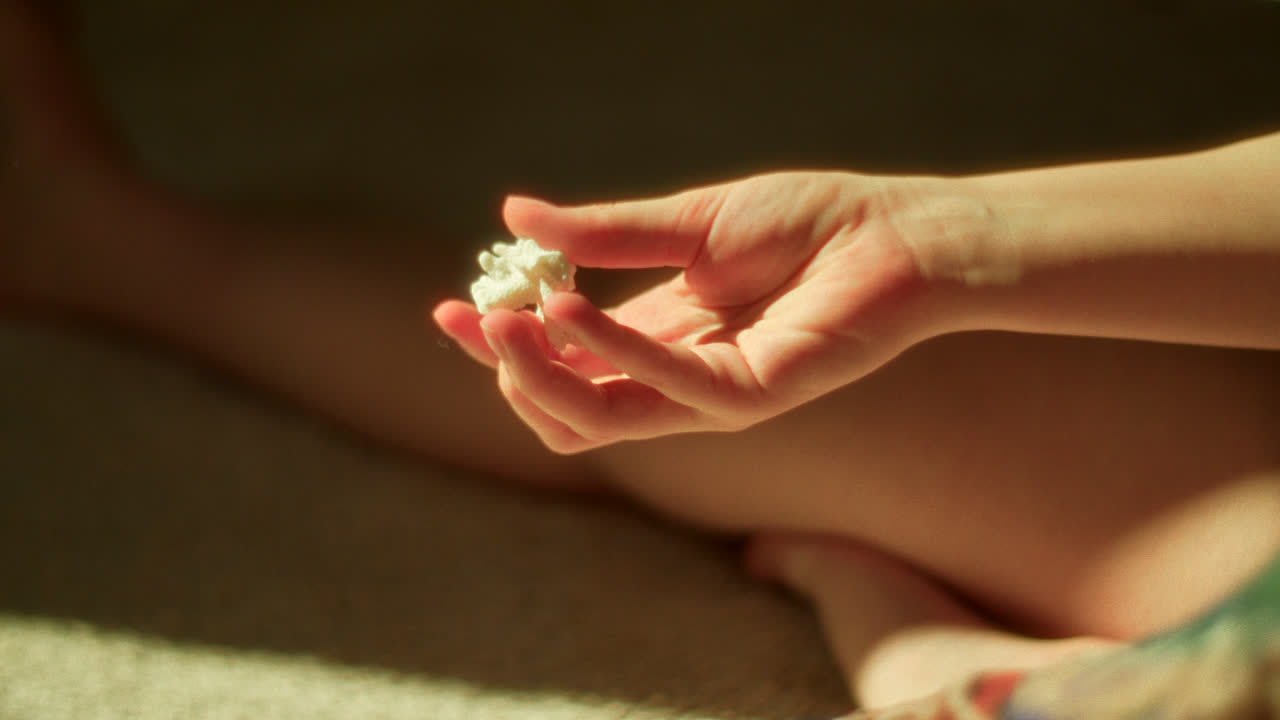A woman holding a small coral piece