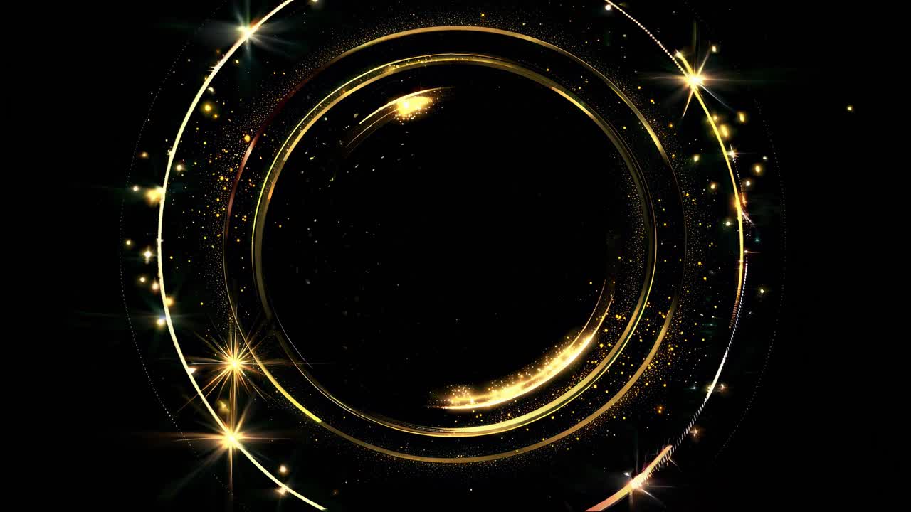 A top-down video view of a glowing, golden circular pattern with sparkling stars on a black