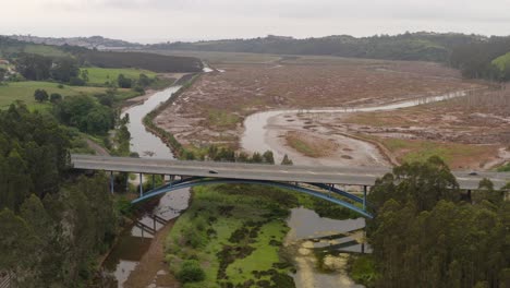 Wide-aerial-view-of-bridge-crossing-rivers-on-wetland