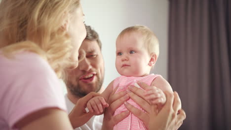 mother shaking head for baby. joyful family have fun. cute infant smile to mom