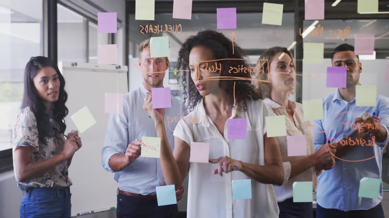 Professional businesswoman writing on glassboard in modern office in slow motion