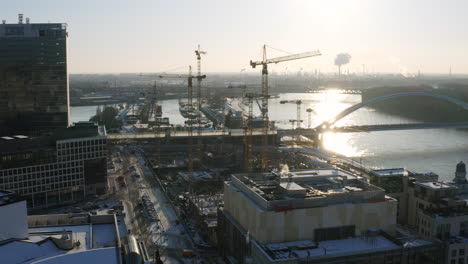 aerial shot of construction site development with lot of cranes during winter morning in slovakia capital city bratislava