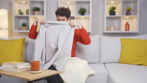 Man-trying-on-clothes-at-home.