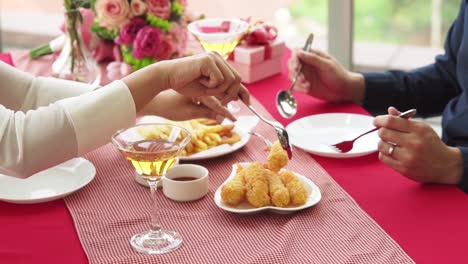 happy romantic couple eating lunch at restaurant