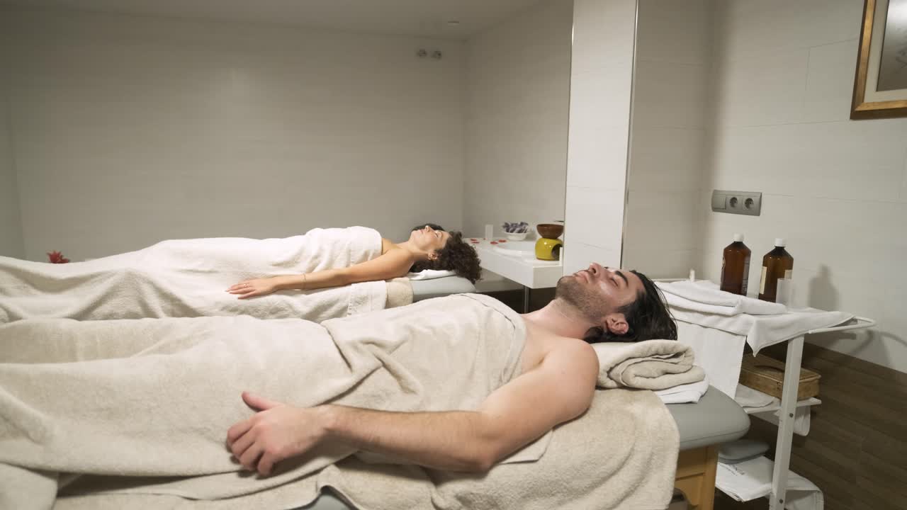 Couple enjoying a relaxing spa experience on massage tables