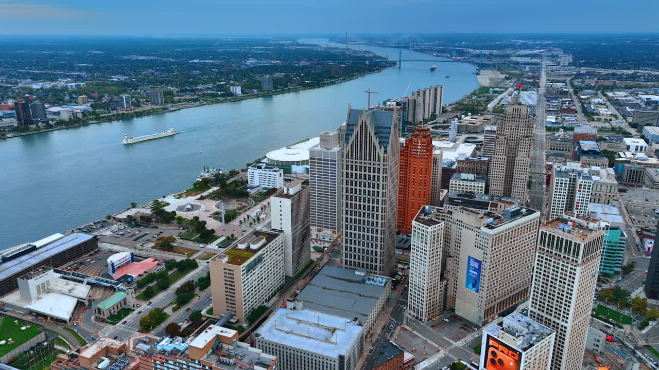 Detroit, USA, 28 July 2025: Detroit Riverfront and Downtown Skyline with Industrial Ship. A wide aerial view captures the downtown Detroit skyline from the riverfront
