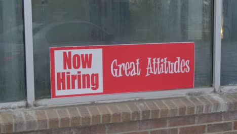 now hiring great attitudes bright red and white sign in window of car wash with condensation and dew on glass, reflection of cars and people, static camera angle in cinema 4k 30fps slowed from 60fps