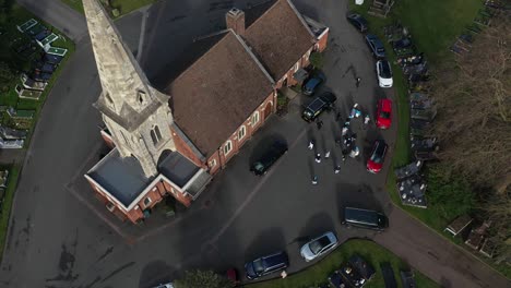 bird eye view of families infront of a church in the middle of cemetery, london