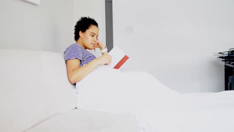 Woman-reading-a-book-on-bed-in-bedroom-4k