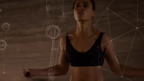 Animation-of-network-of-connections-over-fit-biracial-woman-exercising-on-jumping-rope